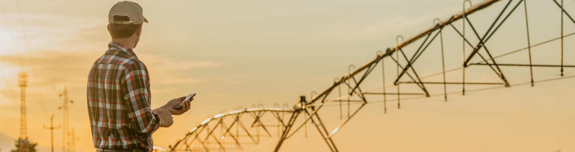 Farmer standing under irrigation system