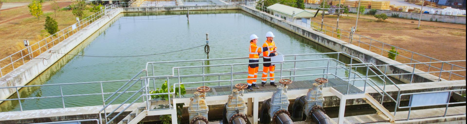 Two Environmental engineers work at wastewater treatment plants, Water management concept