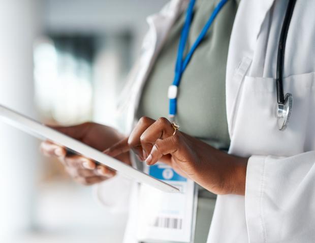 Healthcare, doctor and tablet in hands at hospital for telehealth, research and online prescription. Insurance, clinic and female with digital tech for medical report, data analysis and patient care_BLOG LIST IMAGE