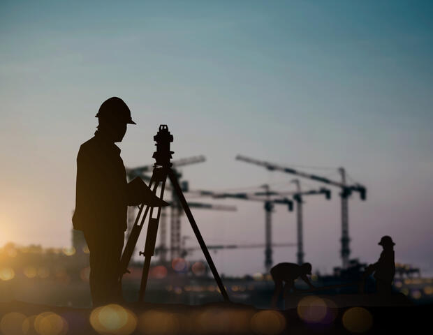 Surveyor using topography equipment 