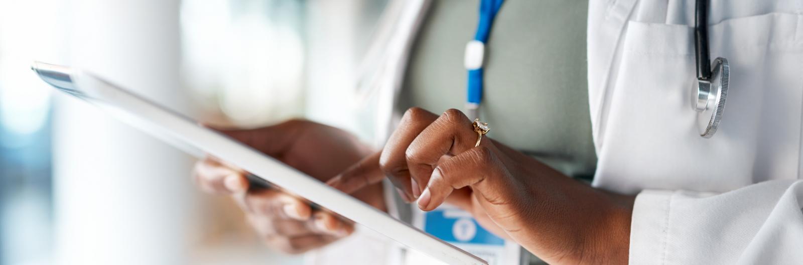 Healthcare, doctor and tablet in hands at hospital for telehealth, research and online prescription. Insurance, clinic and female with digital tech for medical report, data analysis and patient care